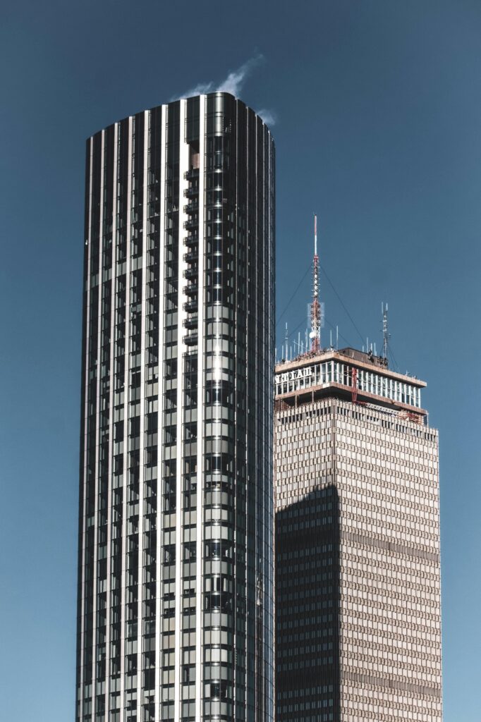 Dramatic Boston skyline with the iconic Prudential Tower under a clear blue sky.